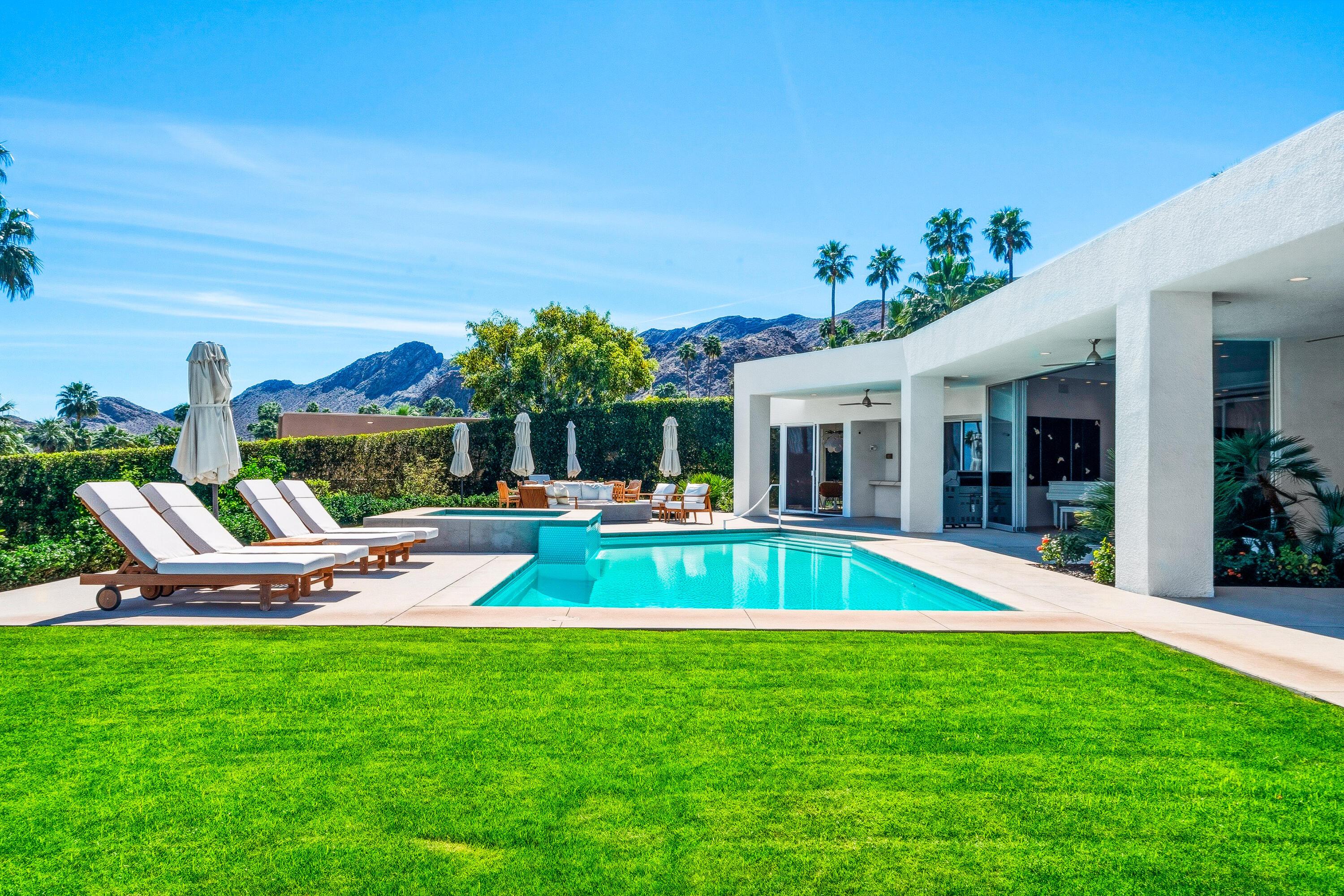 70288 Pecos Road Rancho Mirage, CA 92270 - Photo 2 of 69 a view of a house with a yard patio and swimming pool