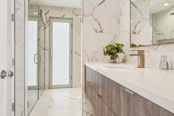 a bathroom with a tub sink and mirror
