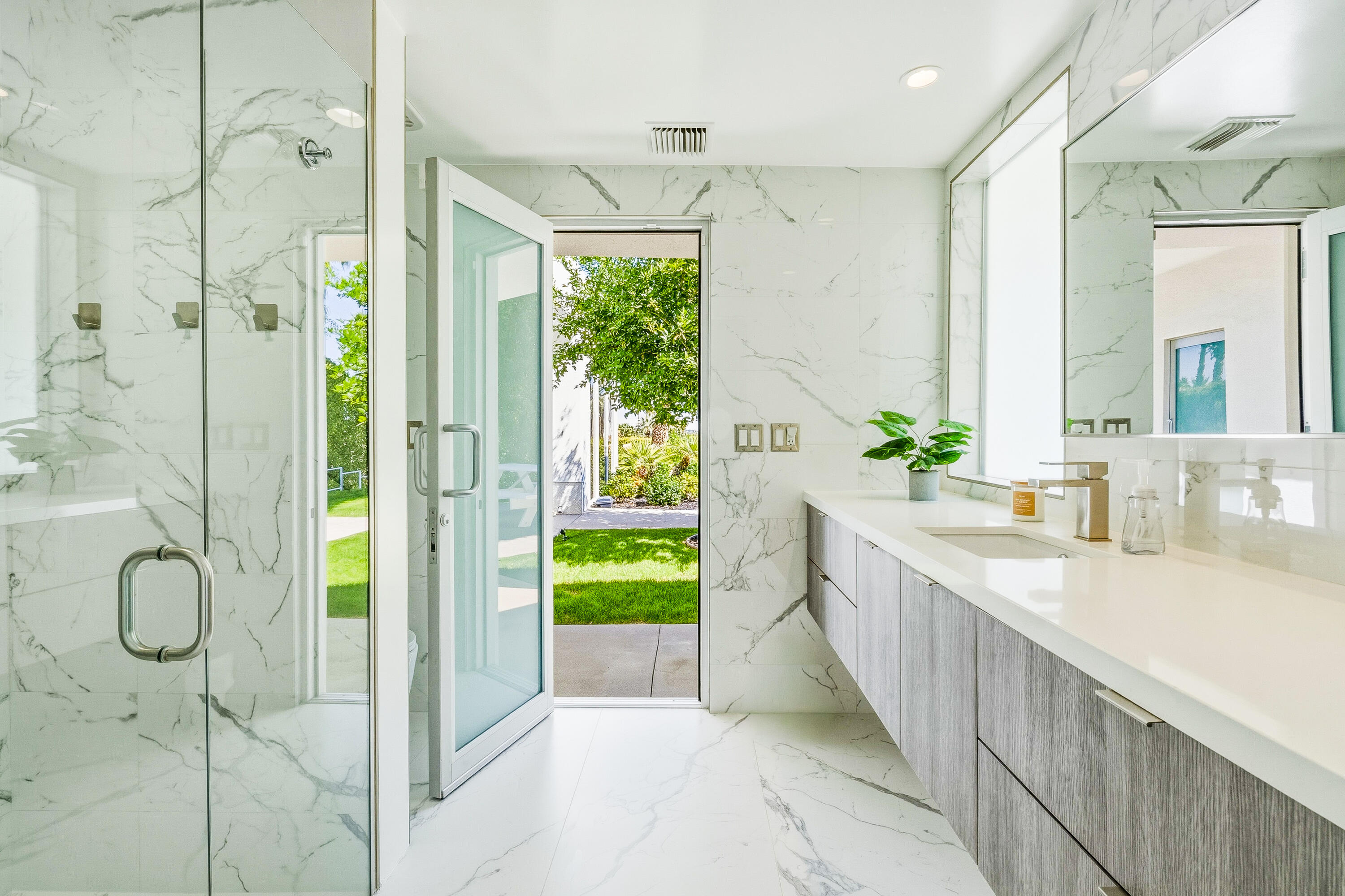 70288 Pecos Road Rancho Mirage, CA 92270 - Photo 29 of 69 a bathroom with a granite countertop sink a toilet and a shower
