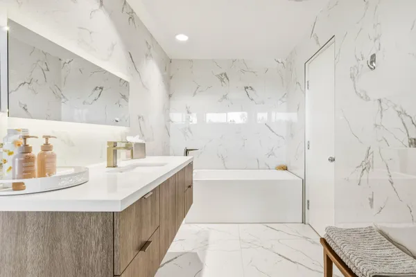 a bathroom with a bathtub and sink
