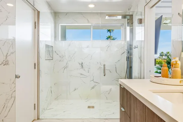 a bathroom with a double vanity sink mirror and bathtub