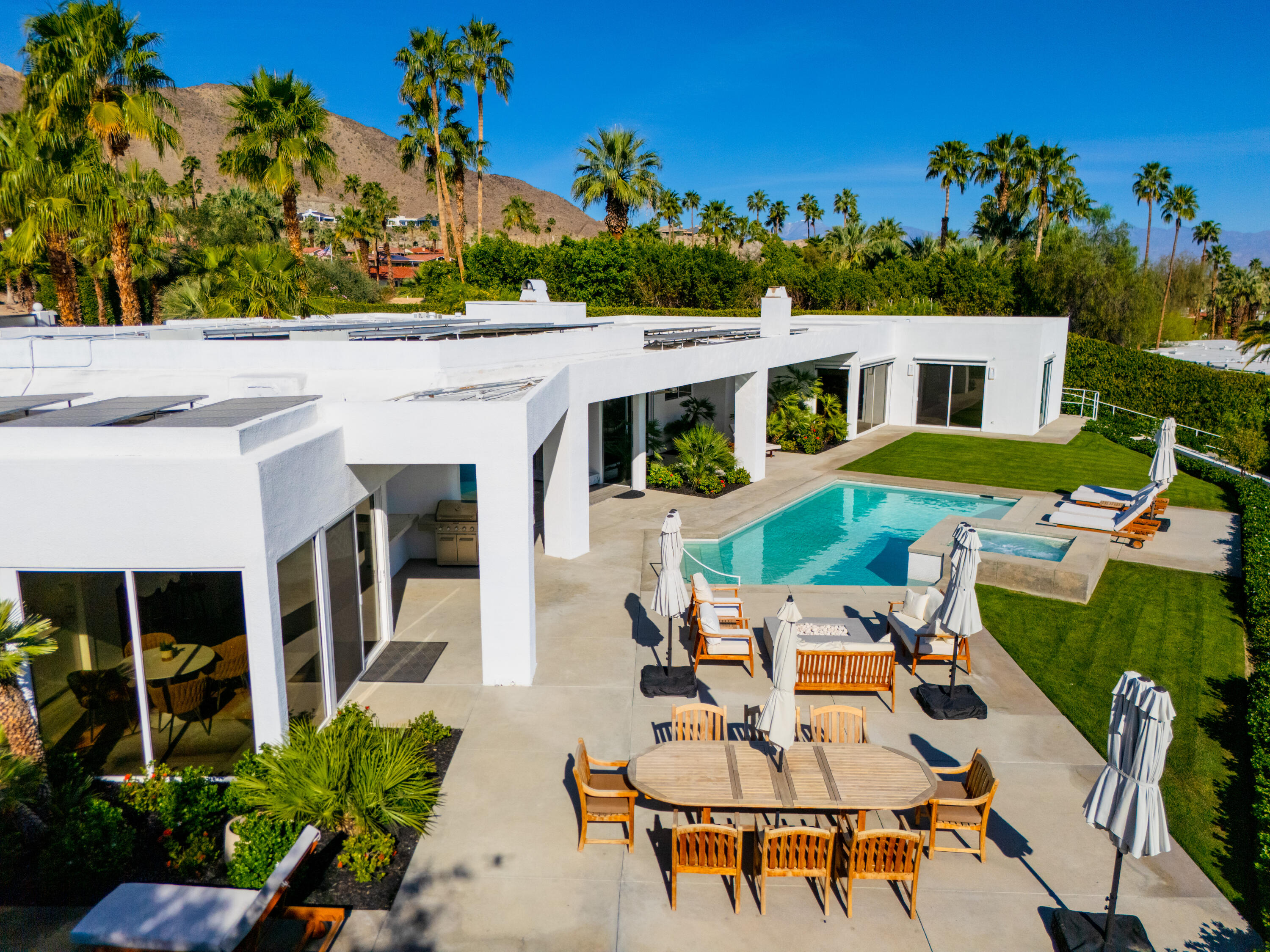 70288 Pecos Road Rancho Mirage, CA 92270 - Photo 61 of 69 a view of a patio with table and chairs potted plants and large tree