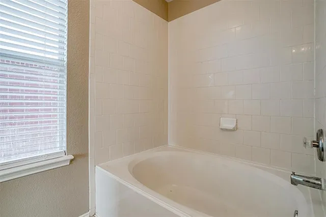 a white bath tub sitting next to a window
