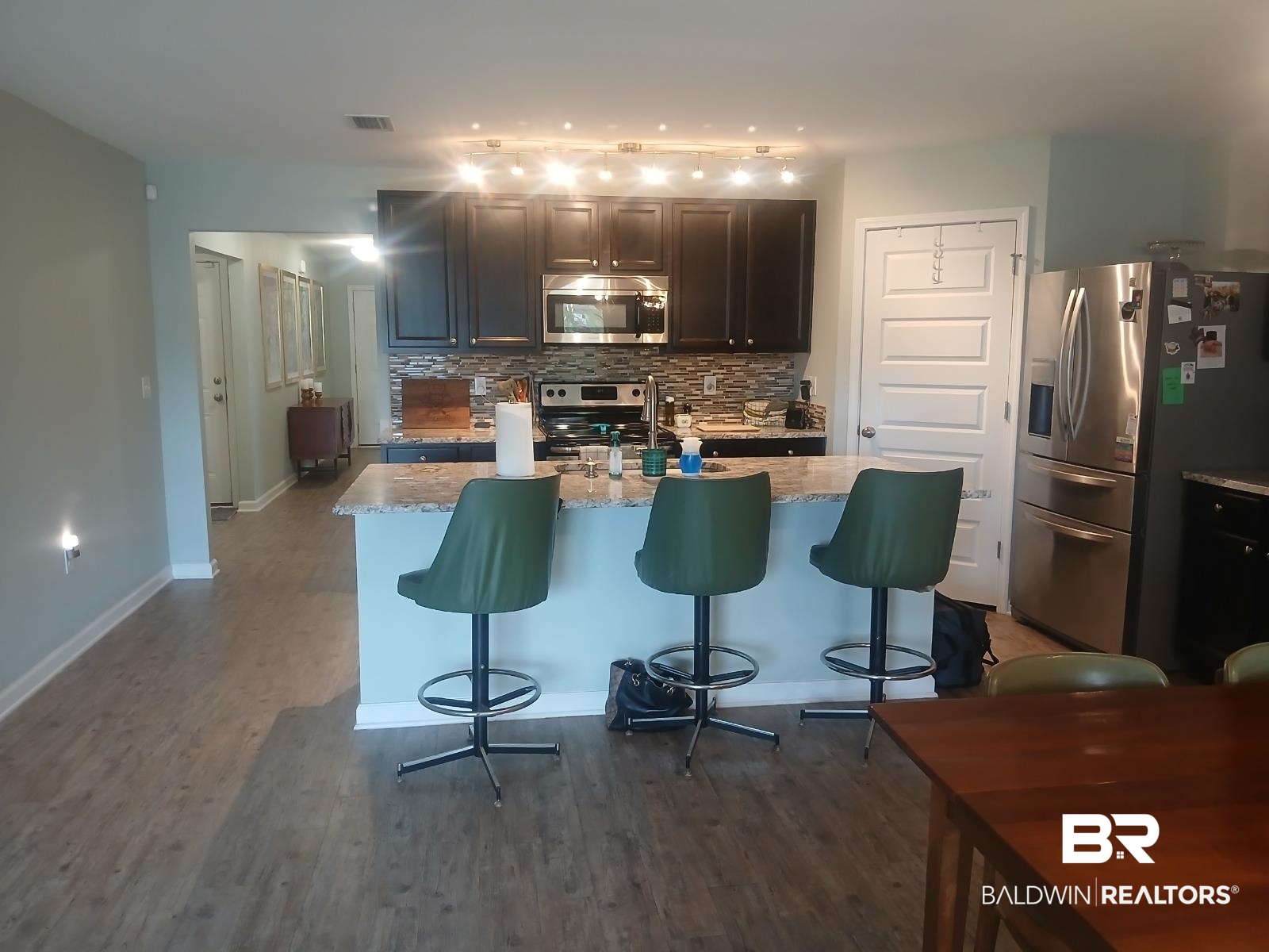 17431 Harding Drive Foley, AL 36535 - Photo 3 of 24 Kitchen with light stone counters, tasteful backsplash, stainless steel appliances, and hardwood / wood-style floors