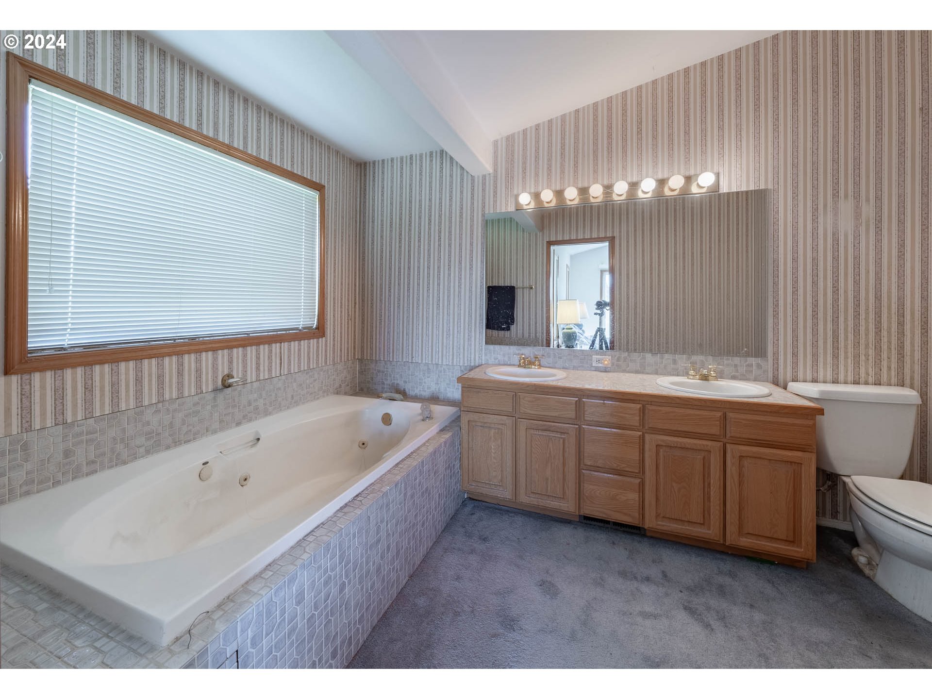 16500 Falls City Road Dallas, OR 97338 - Photo 16 of 36 a bathroom with a tub a double vanity sink and mirror