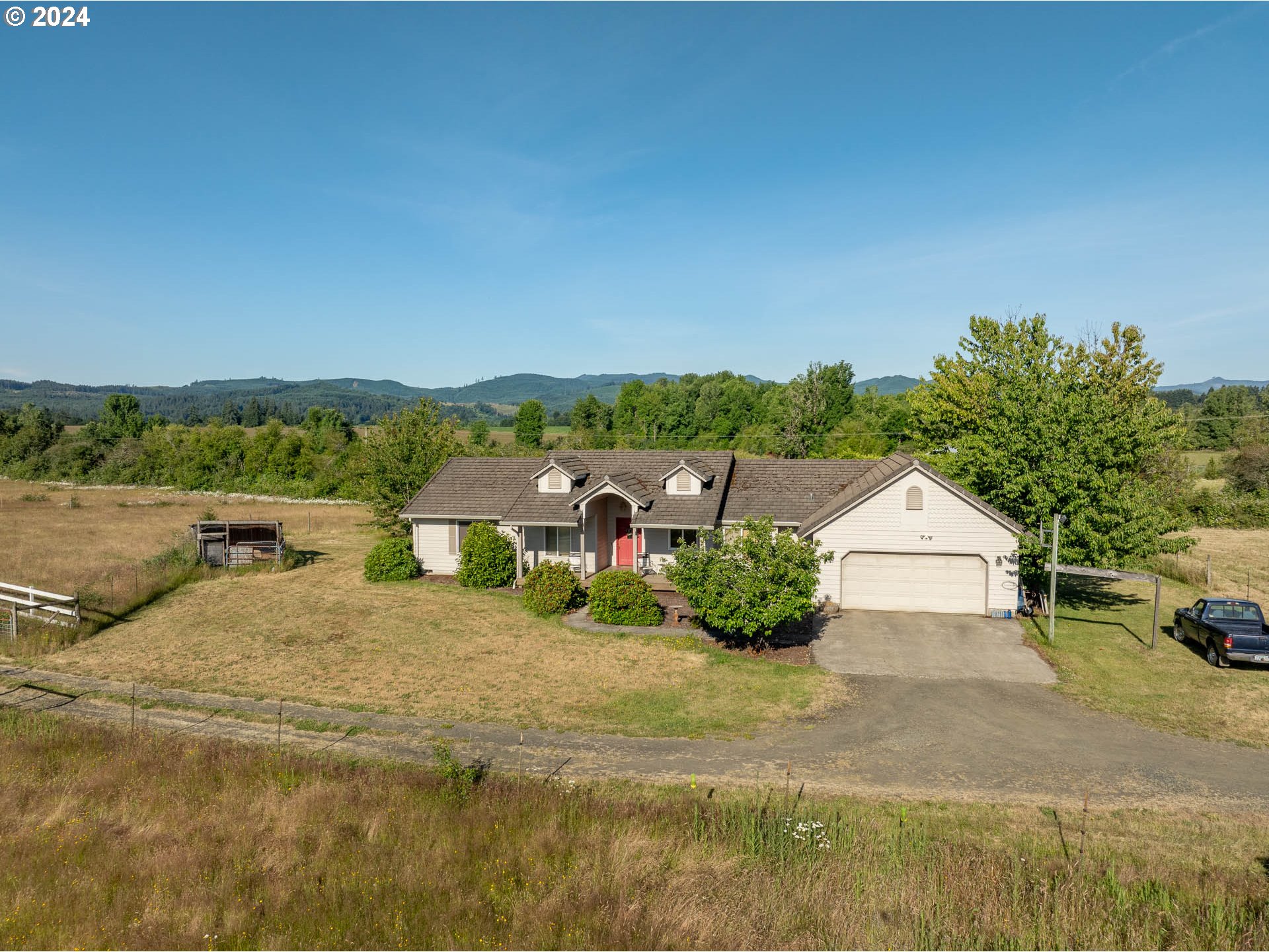 16500 Falls City Road Dallas, OR 97338 - Photo 2 of 36 a view of a white house with a yard and large trees