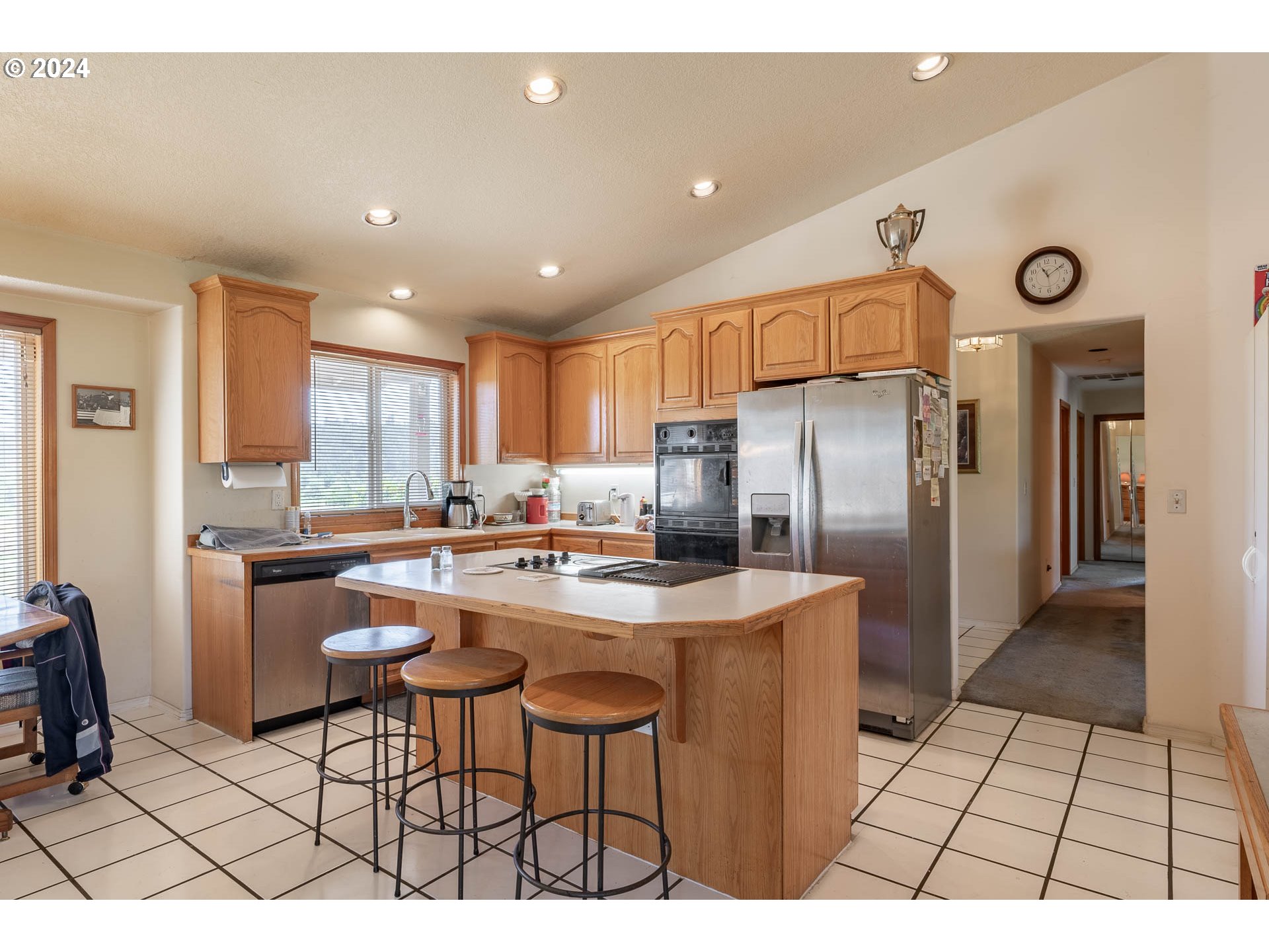 16500 Falls City Road Dallas, OR 97338 - Photo 9 of 36 a kitchen with stainless steel appliances a refrigerator a sink a stove a dining table and chairs