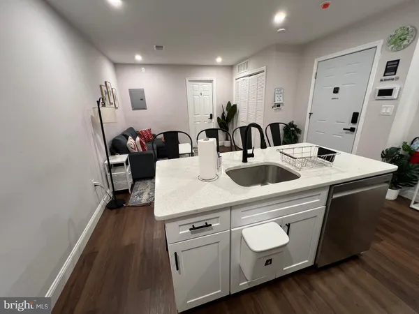 a kitchen with a sink a stove and cabinets