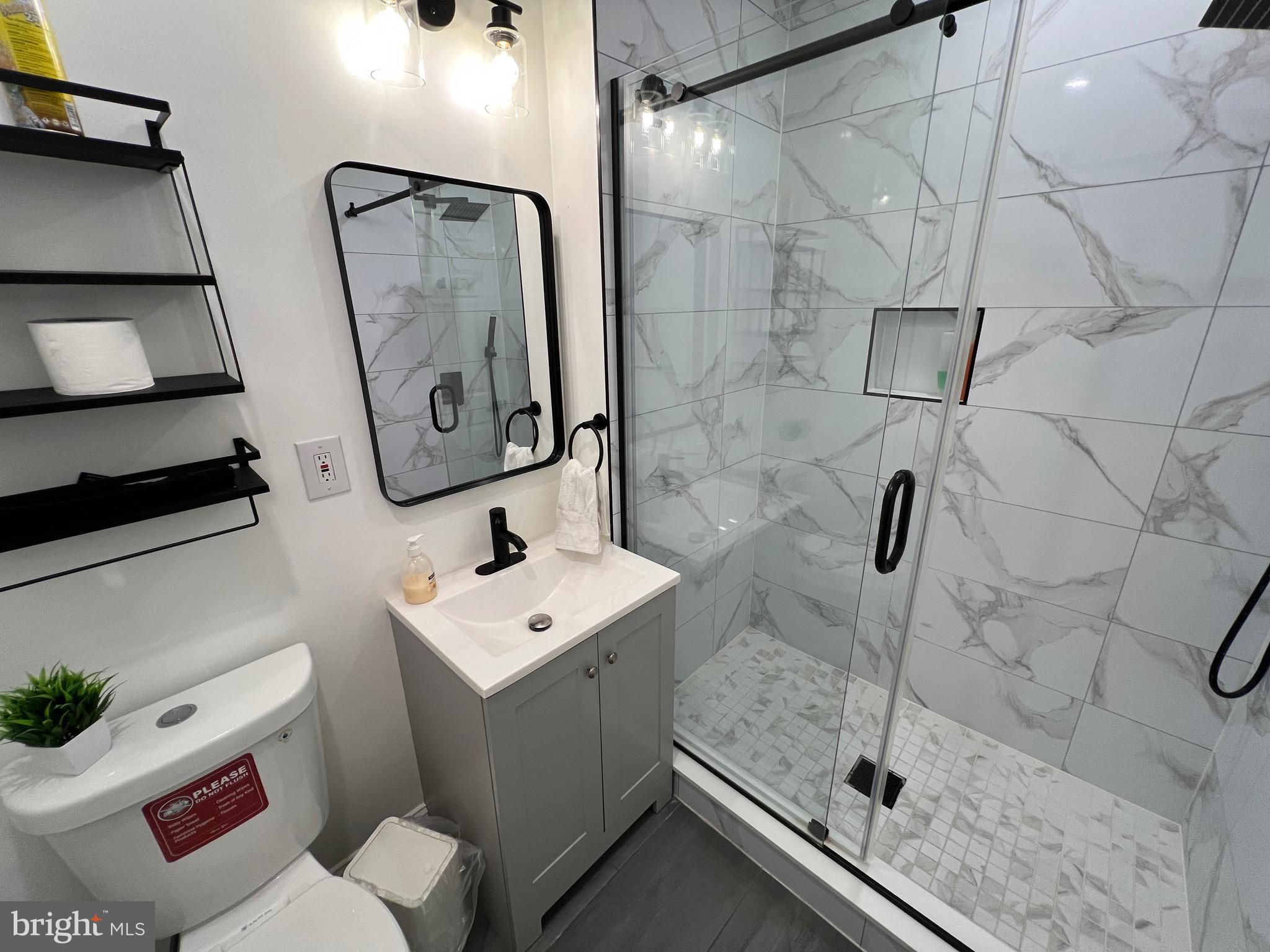 1985 North 63rd Street, Unit 3 Philadelphia, PA 19151 - Photo 11 of 23 a bathroom with a sink toilet and shower