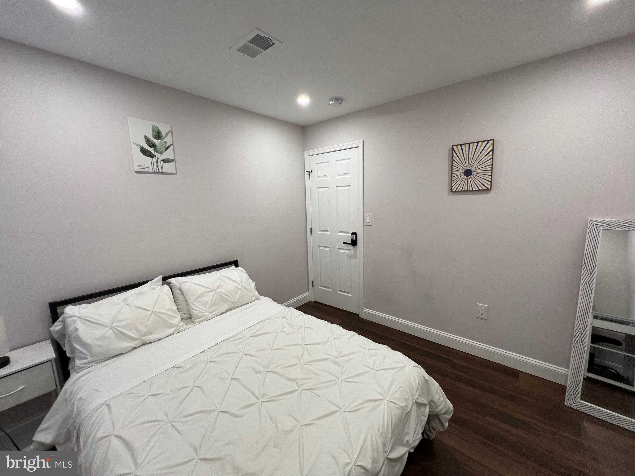 1985 North 63rd Street, Unit 3 Philadelphia, PA 19151 - Photo 15 of 23 a bedroom with a bed and a flat screen tv