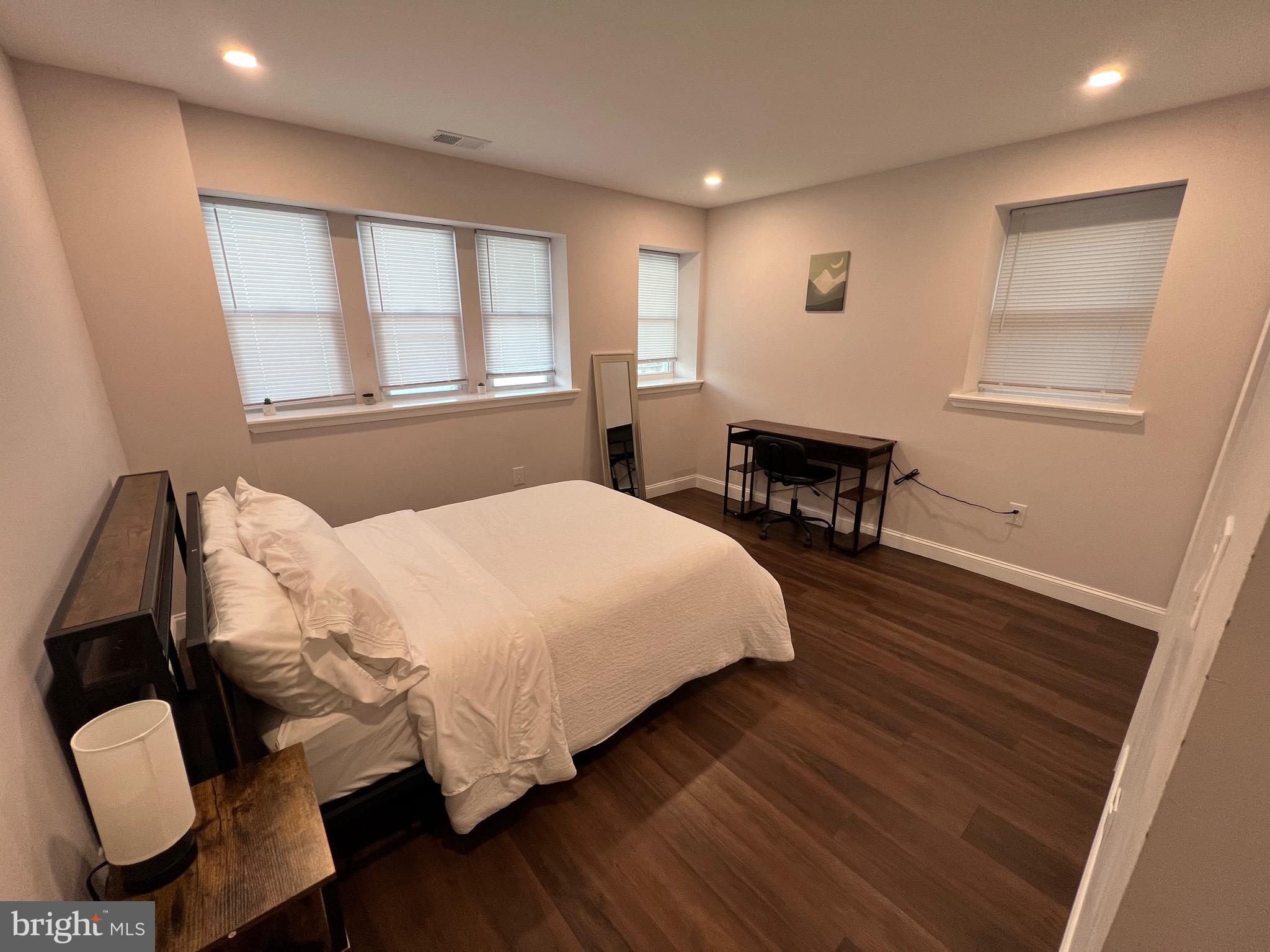 1985 North 63rd Street, Unit 3 Philadelphia, PA 19151 - Photo 18 of 23 a bedroom with a bed and wooden floor