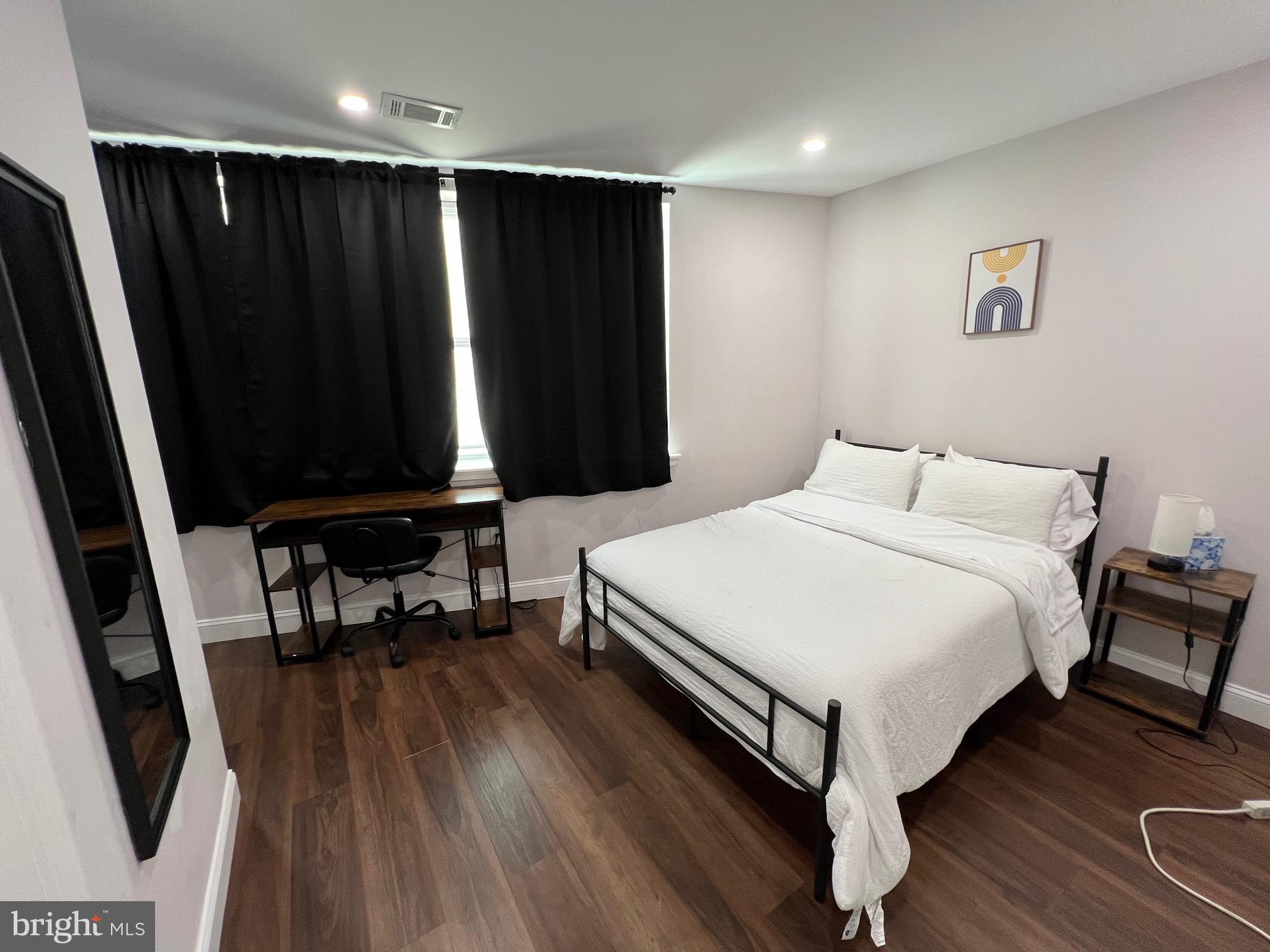 1985 North 63rd Street, Unit 3 Philadelphia, PA 19151 - Photo 9 of 23 a bedroom with a bed and a black bathroom