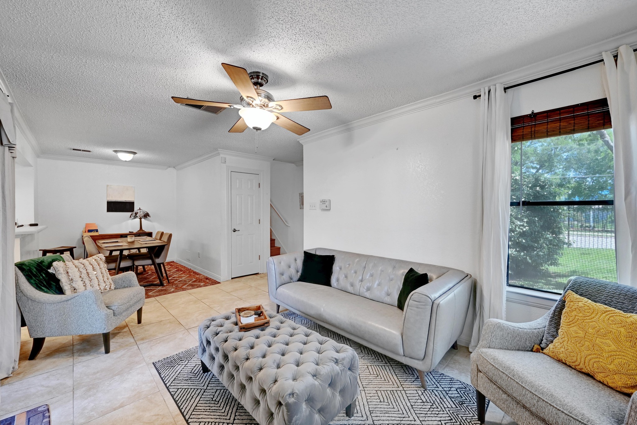 7635 Guadalupe Street, Unit 1002 Austin, TX 78752 - Photo 5 of 27 a living room with furniture ceiling fan and a rug