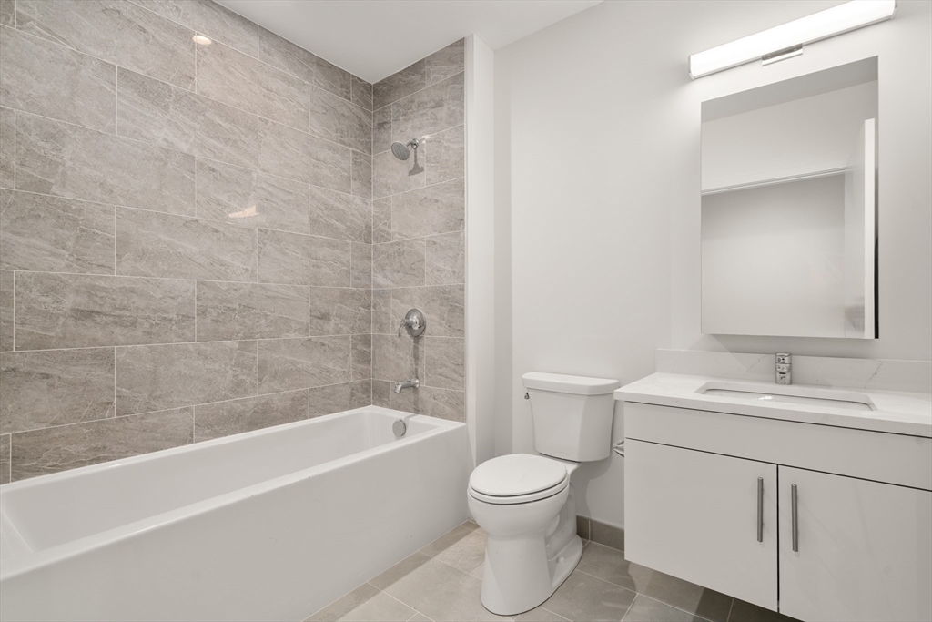 1151 Walnut Street, Unit 406 Newton, MA 02461 - Photo 20 of 32 a bathroom with a sink toilet and bathtub