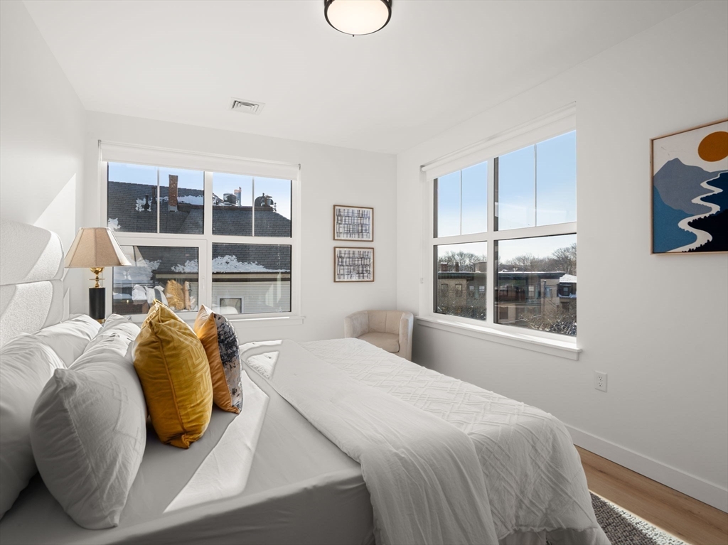 1151 Walnut Street, Unit 406 Newton, MA 02461 - Photo 8 of 32 a bedroom with a bed and balcony