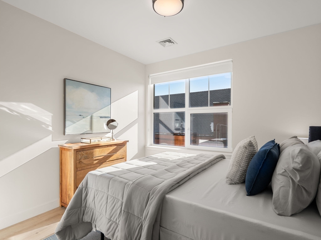 1151 Walnut Street, Unit 406 Newton, MA 02461 - Photo 9 of 32 a bedroom with a bed and a window