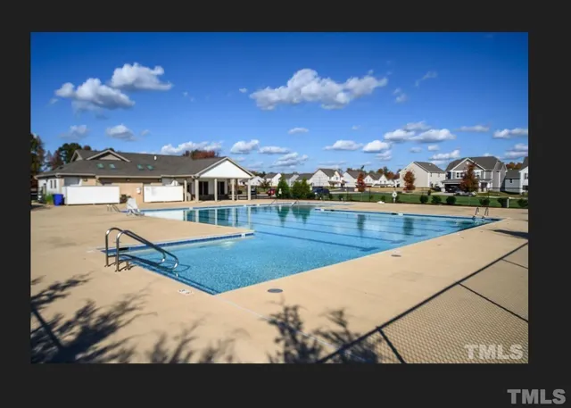 a view of swimming pool with a yard