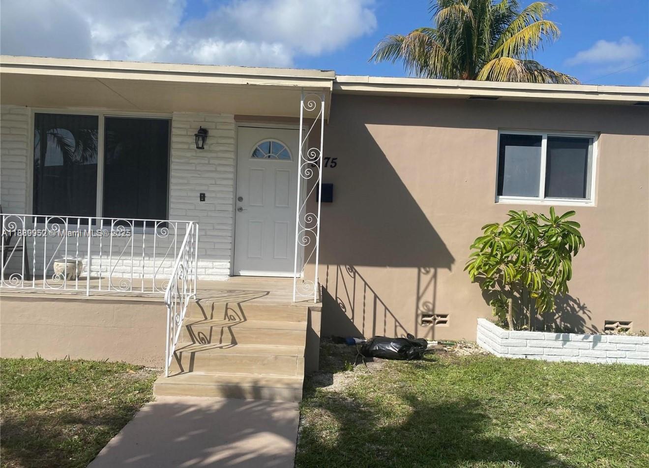 3175 Southwest 27th Terrace, Unit 3175 Miami, FL 33133 - Photo 2 of 17 a front view of a house with a yard