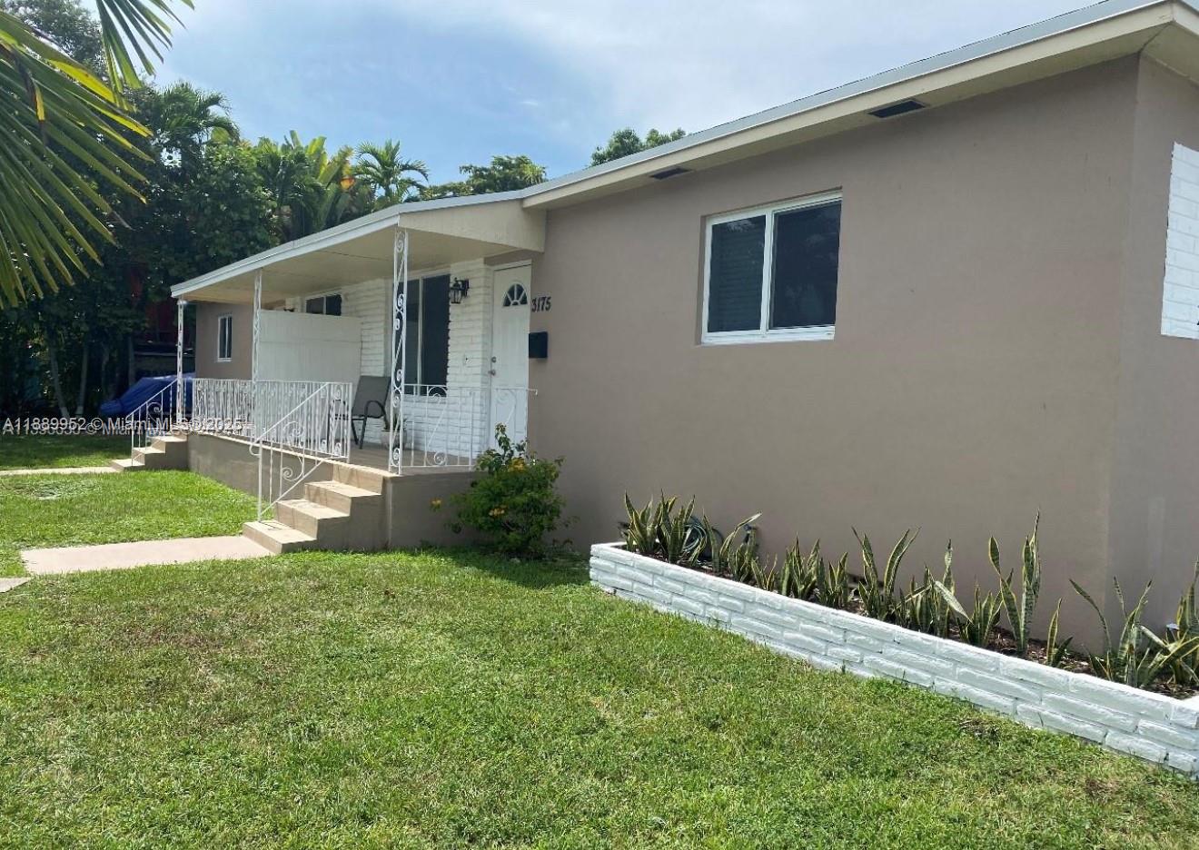3175 Southwest 27th Terrace, Unit 3175 Miami, FL 33133 - Photo 3 of 17 a view of a house with backyard and sitting area