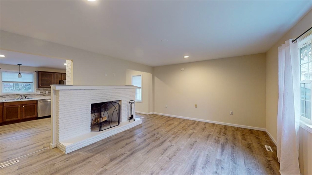 195 Riverton Road Springfield, MA 01109 - Photo 11 of 42 a view of an empty room with a fireplace and a window