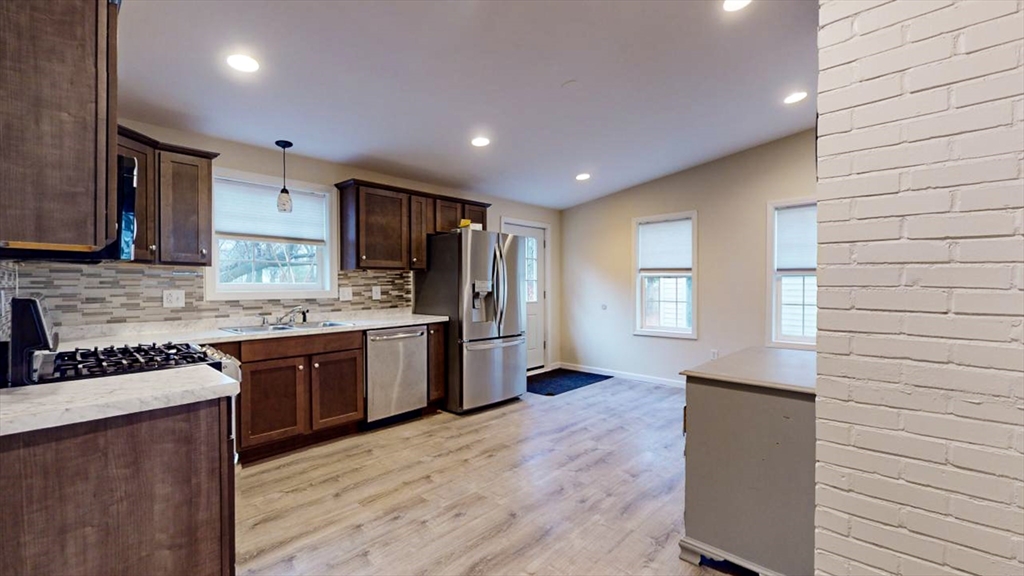 195 Riverton Road Springfield, MA 01109 - Photo 17 of 42 a kitchen with stainless steel appliances granite countertop wooden cabinets a stove top oven a sink and dishwasher
