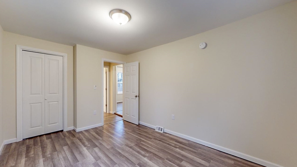 195 Riverton Road Springfield, MA 01109 - Photo 19 of 42 a view of an empty room with wooden floor