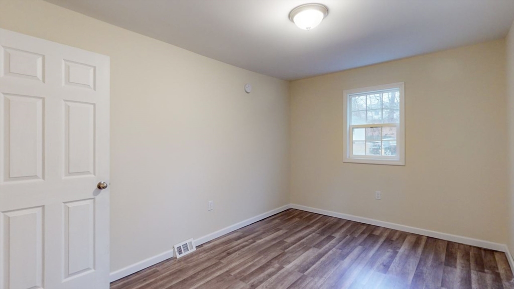 195 Riverton Road Springfield, MA 01109 - Photo 20 of 42 an empty room with wooden floor and windows