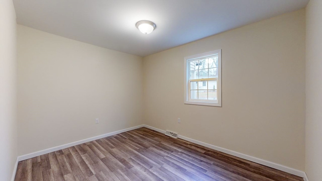 195 Riverton Road Springfield, MA 01109 - Photo 28 of 42 an empty room with wooden floor and windows
