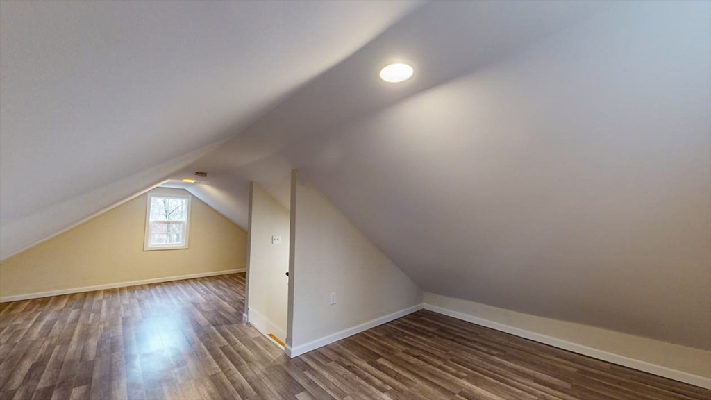 195 Riverton Road Springfield, MA 01109 - Photo 30 of 42 a view of an empty room with wooden floor and a window