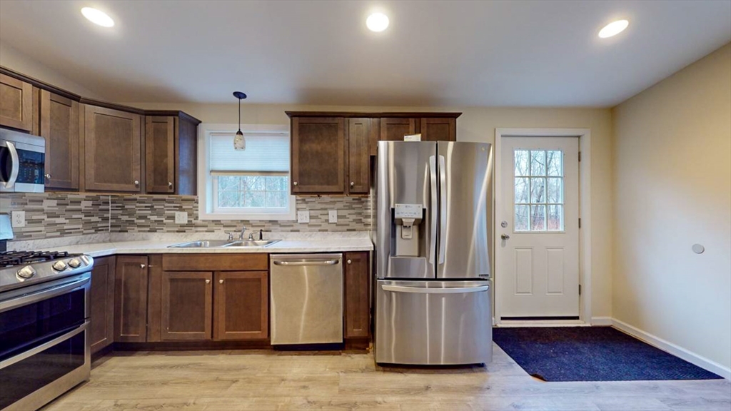 195 Riverton Road Springfield, MA 01109 - Photo 3 of 42 a kitchen with stainless steel appliances granite countertop a refrigerator and a stove top oven