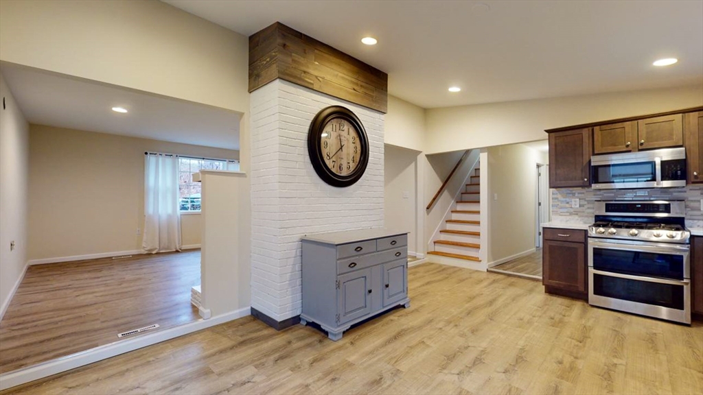 195 Riverton Road Springfield, MA 01109 - Photo 9 of 42 a kitchen with stainless steel appliances granite countertop a stove and a sink