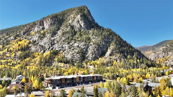 a large kitchen with a fireplace and a chandelier