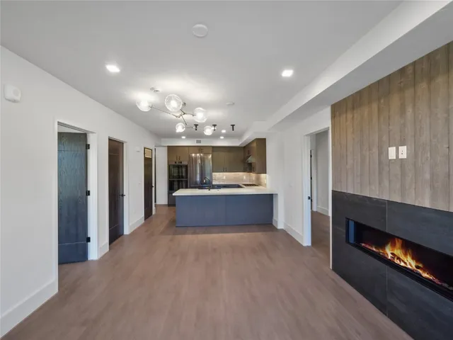 a view of kitchen and hall with wooden floor