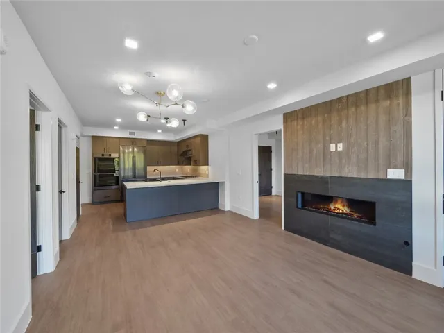 a large kitchen with kitchen island a sink stainless steel appliances and a counter top space