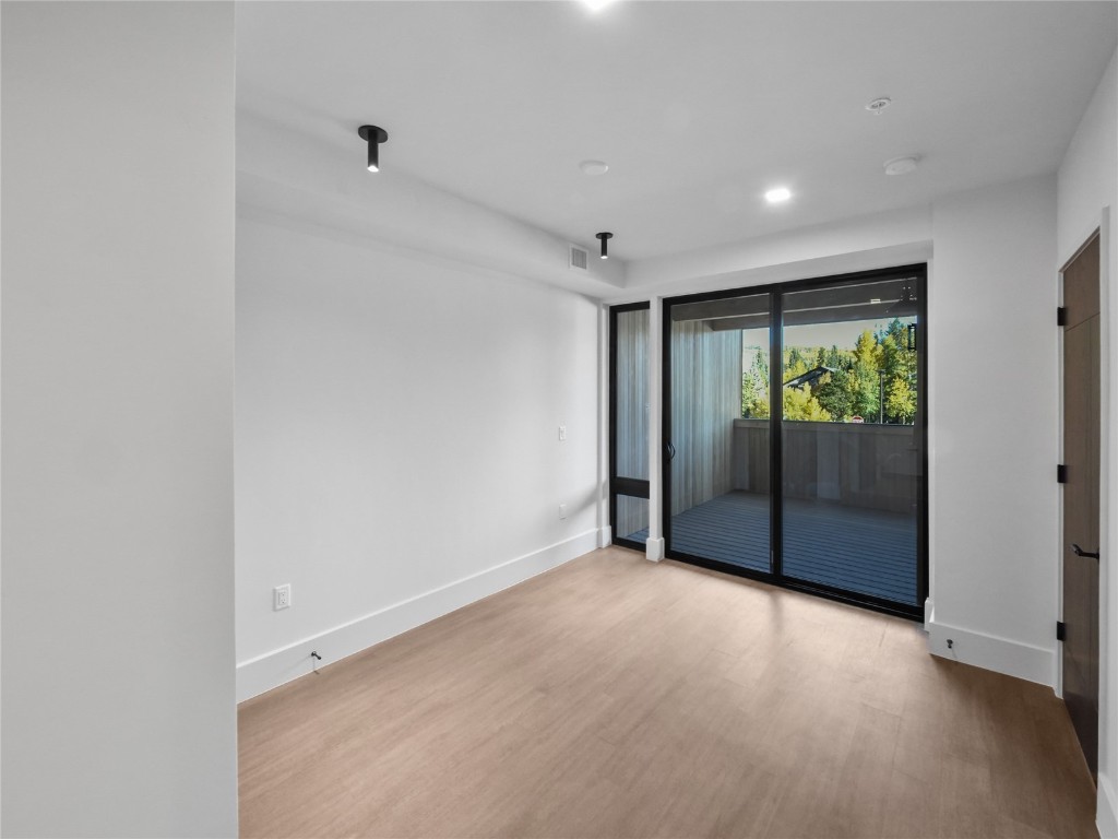 80 West Main Street, Unit 212 Frisco, CO 80443 - Photo 25 of 45 a view of an empty room with wooden floor and a window