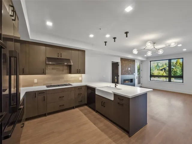 a kitchen with granite countertop stainless steel appliances and counter space