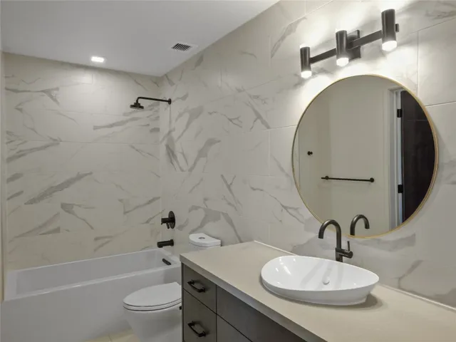 a view of a hallway with a chandelier fan