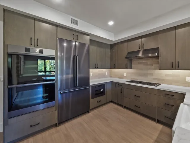 a kitchen with a refrigerator and cabinets