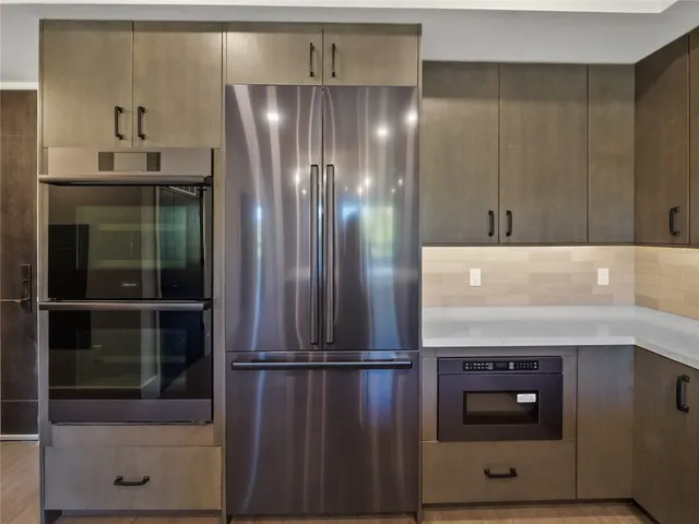 a kitchen with a refrigerator and a sink