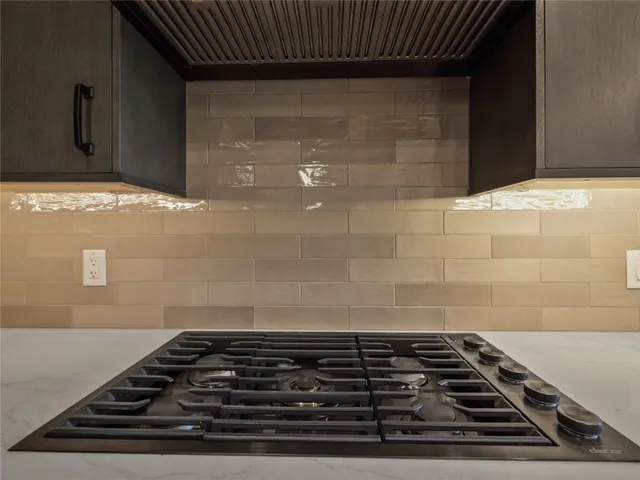 a large kitchen with a sink and a stove top oven