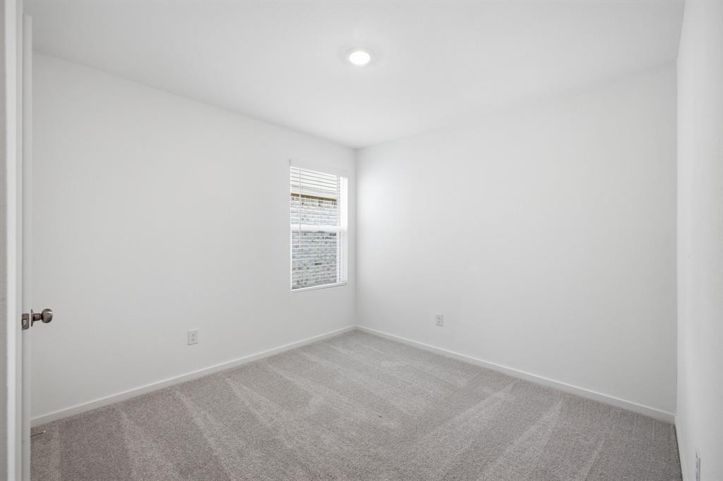 2128 Doc Holliday Road Joshua, TX 76058 - Photo 10 of 28 Neutral white walls with a single window featuring horizontal blinds