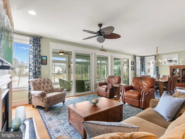 a dining room with furniture and wooden floor