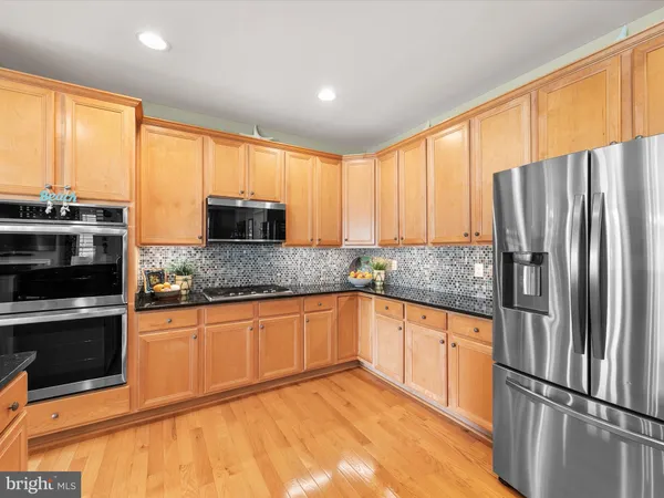 a dining room filled chandelier and kitchen view