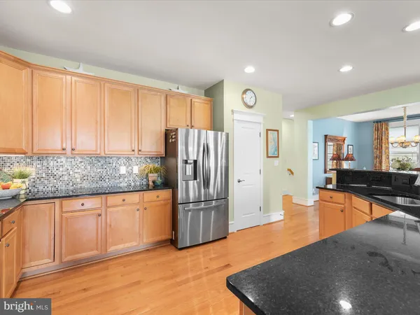 a bedroom with a bed mirror and painting on the wall
