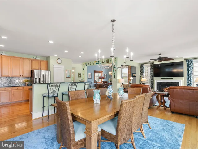 a dining room filled chandelier and kitchen view
