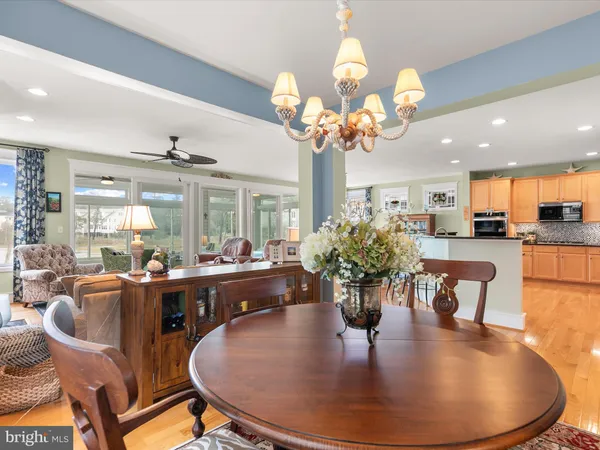 a view of a white house with a small yard and wooden fence
