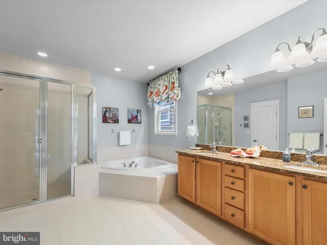 a living room with furniture and large wooden floor