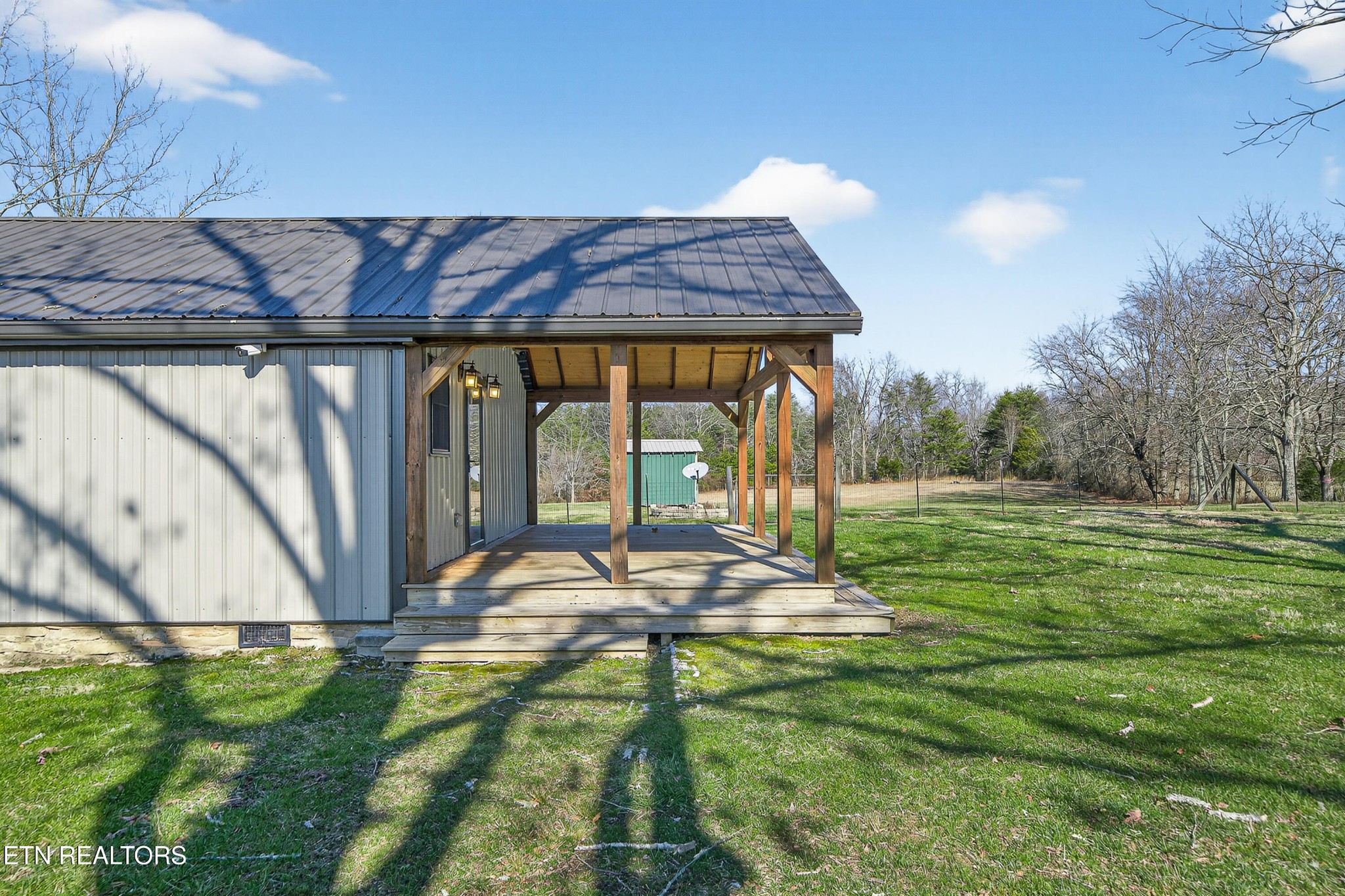 2496 Chestnut Hill Road Crossville, TN 38571 - Photo 23 of 38 a view of a backyard with table and chairs and wooden fence