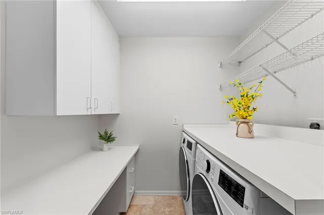 a kitchen with a sink a cabinets and wooden floor
