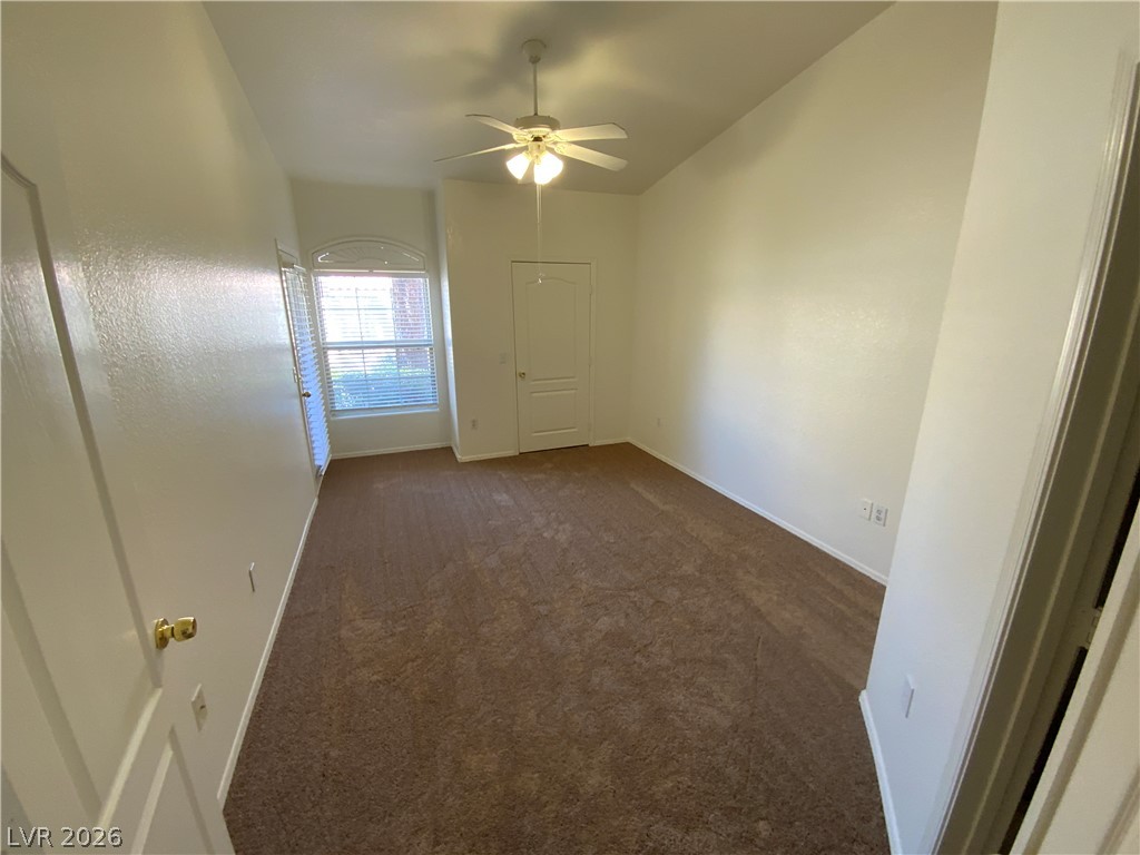 7400 West Flamingo Road, Unit 1039 Las Vegas, NV 89147 - Photo 32 of 40 A well-lit bedroom offering a cozy retreat with soft carpeting and an arched window.
